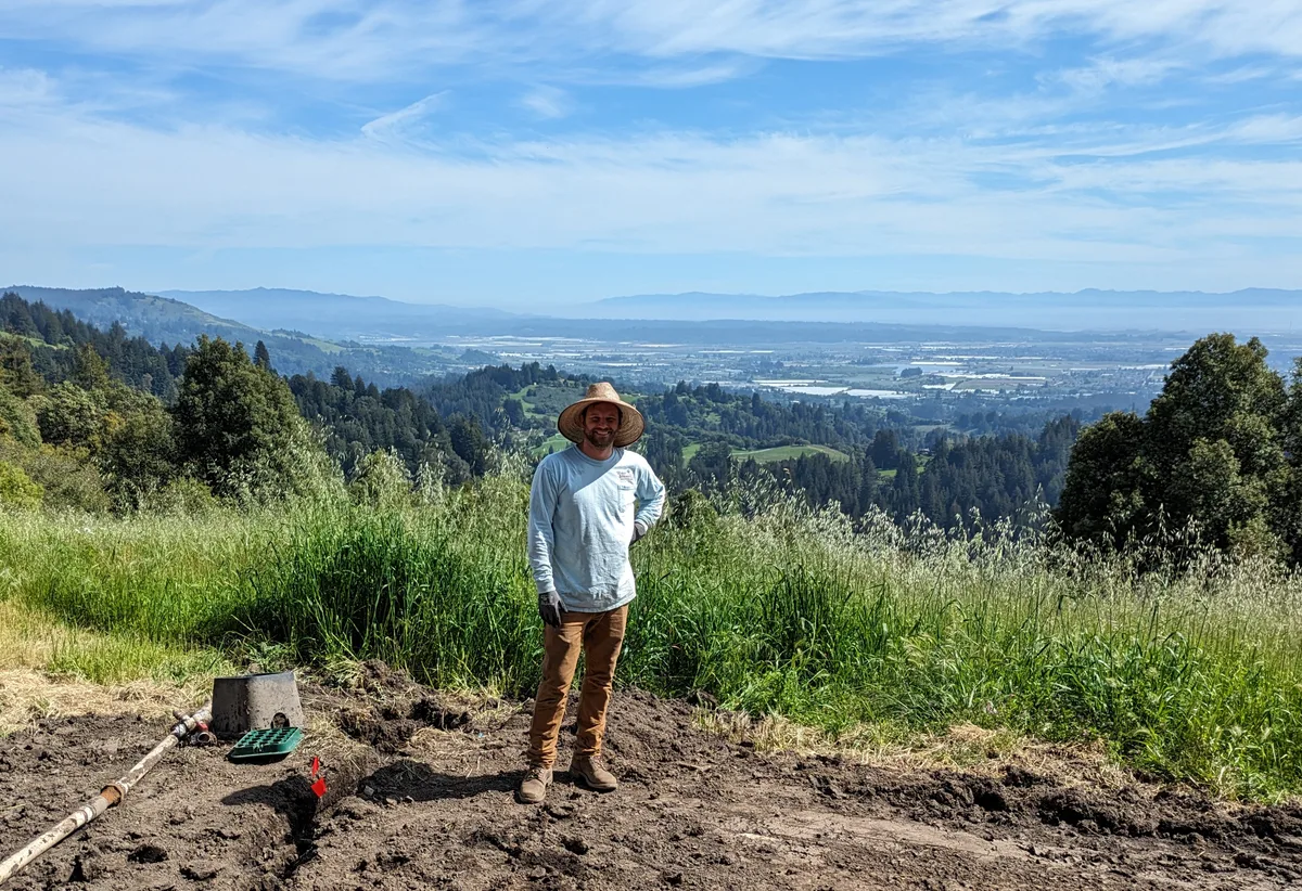 A Water & Stone crew member on a hillside overlooking the Central Coast